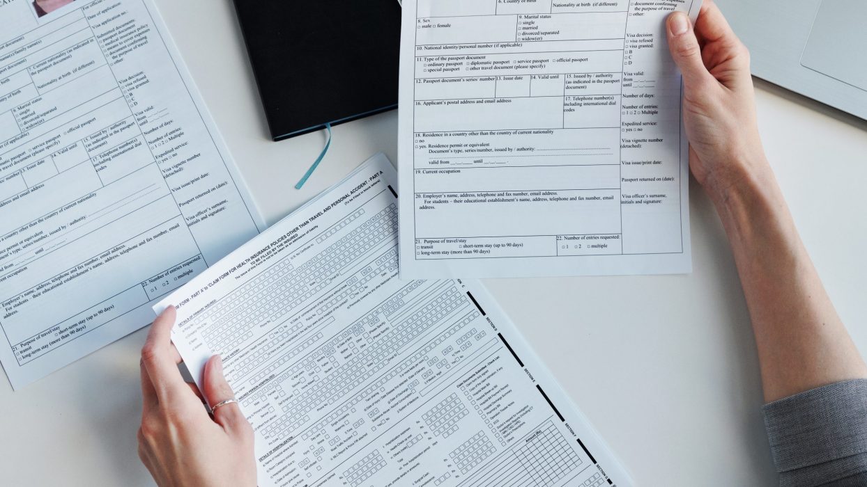 Top-down view shot of unrecognizable woman working in US embassy working with travel visa applications